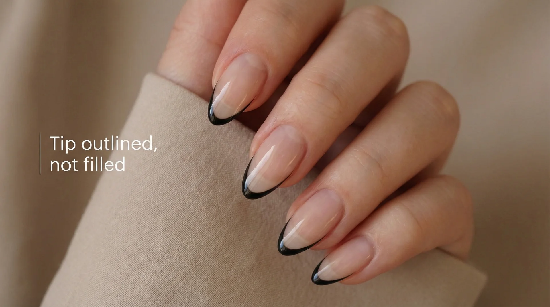 Almond nails with negative space french tip outlined in thin black line, interior clear