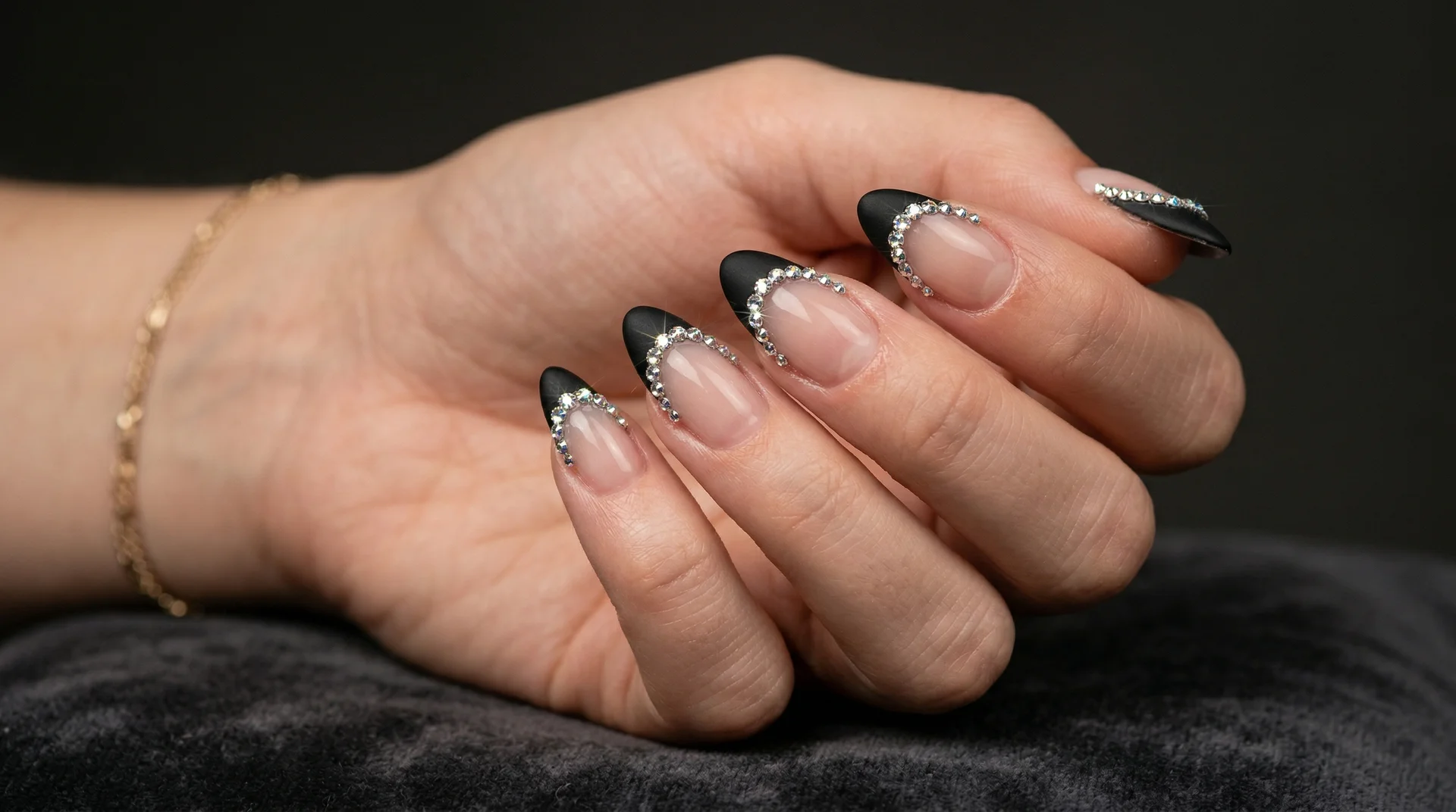 Almond nails with rhinestone crystal-outlined french tip, interior clear or matte black