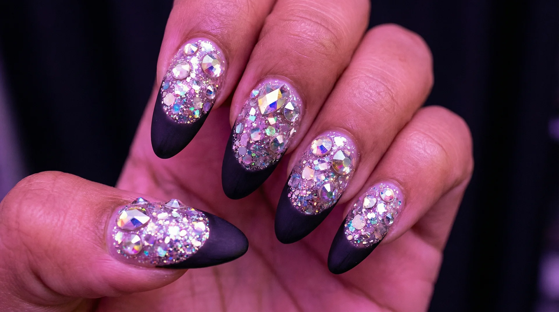 Euphoria-inspired almond nails with rhinestone glitter base and clean matte black french tip