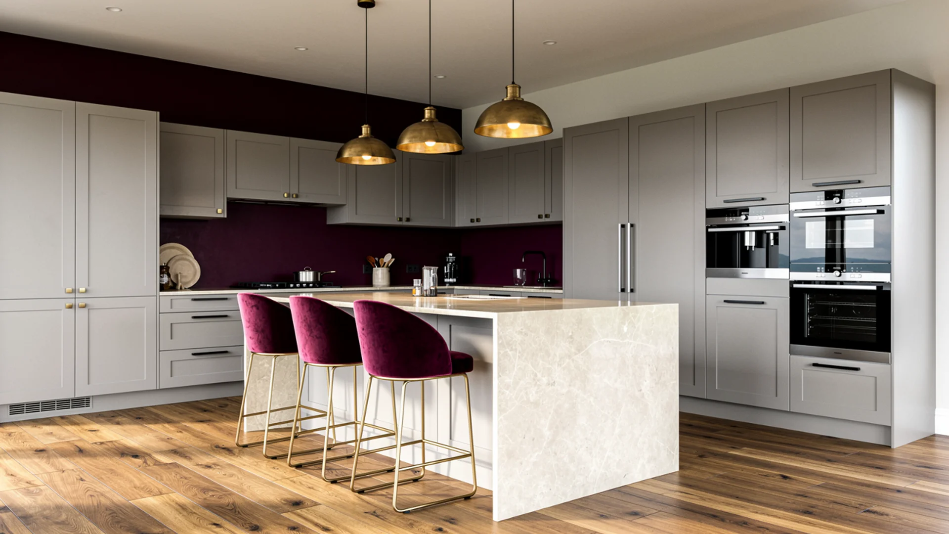 Light grey kitchen with deep burgundy feature wall, stone countertops and antique brass pendant lights
