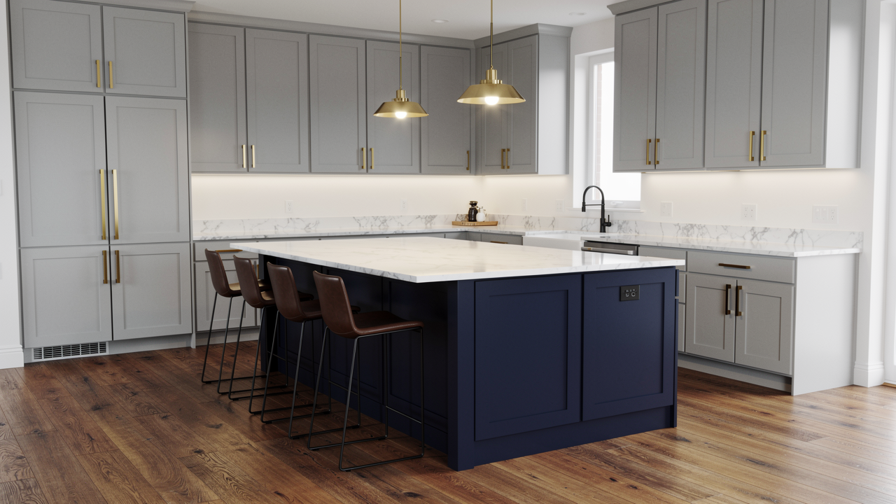 Light grey kitchen with navy blue island, white marble countertop and brass hardware on warm wood floors