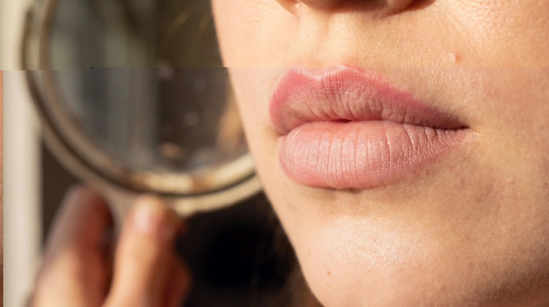 Close-up of naturally faded lip blush at the 3-year mark showing a soft rose-nude tone in warm light