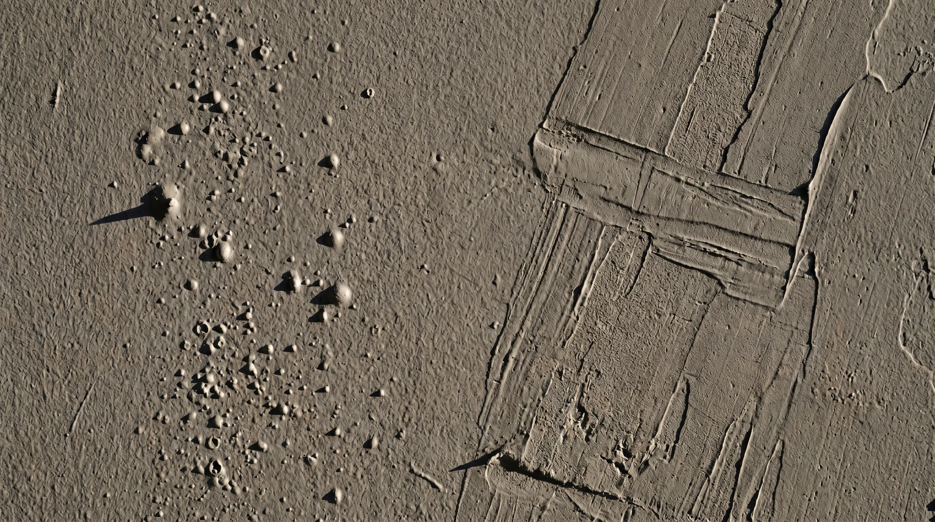 Close-up of paint wall defects: bubbling and roller drag streaks from applying the second coat too early
