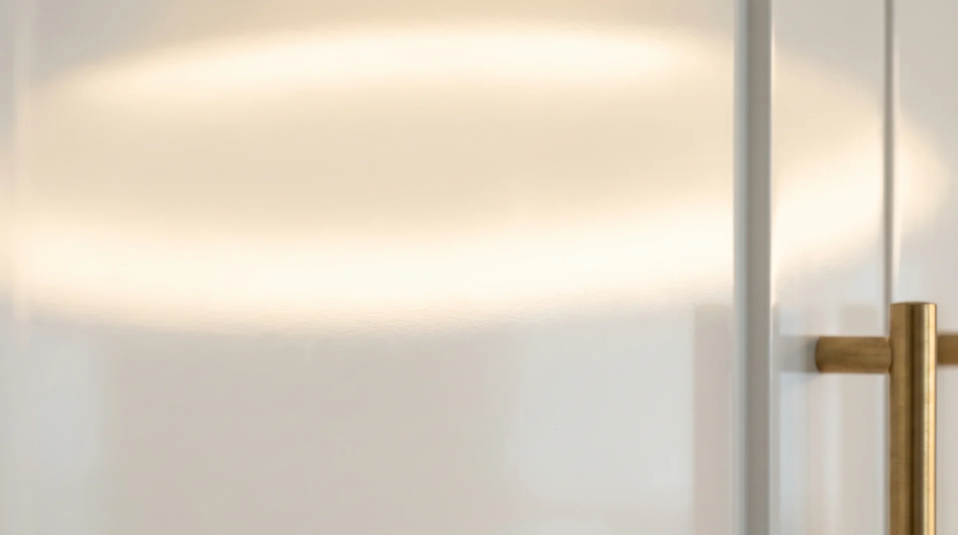 Extreme close-up of smooth urethane-painted white kitchen cabinet door showing a flawless reflective finish