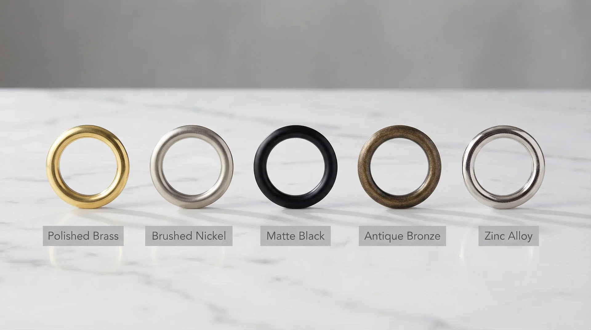 Five curtain grommet finishes in a row: polished brass, brushed nickel, matte black, antique bronze, and zinc alloy 
