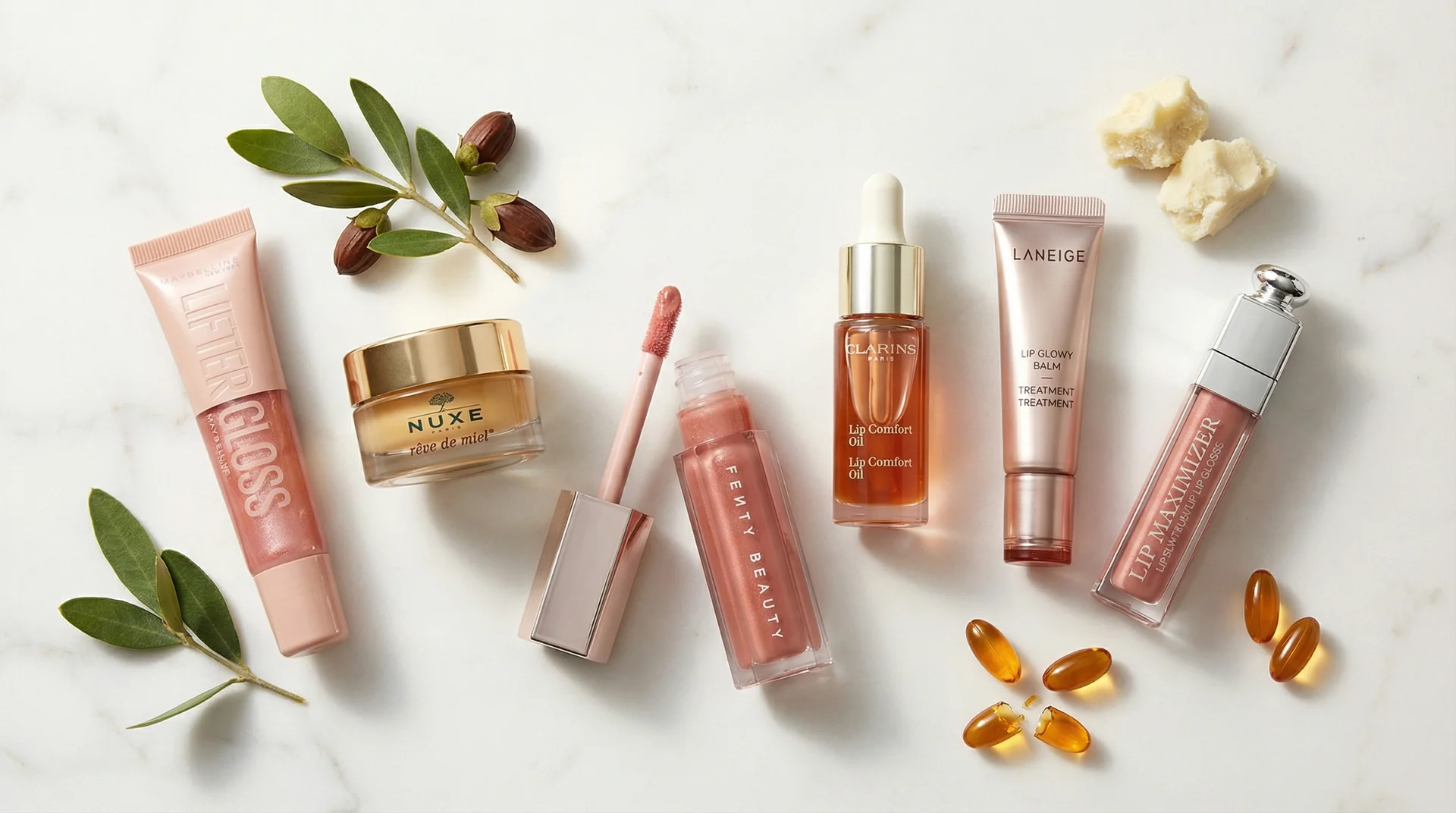 Flat lay of six best hydrating lip glosses on marble with natural ingredients like jojoba and shea butter