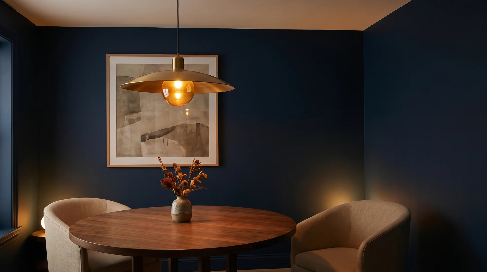 Formal dining room with deep navy flat-painted walls showing rich saturated color and no sheen under warm lamplight.
