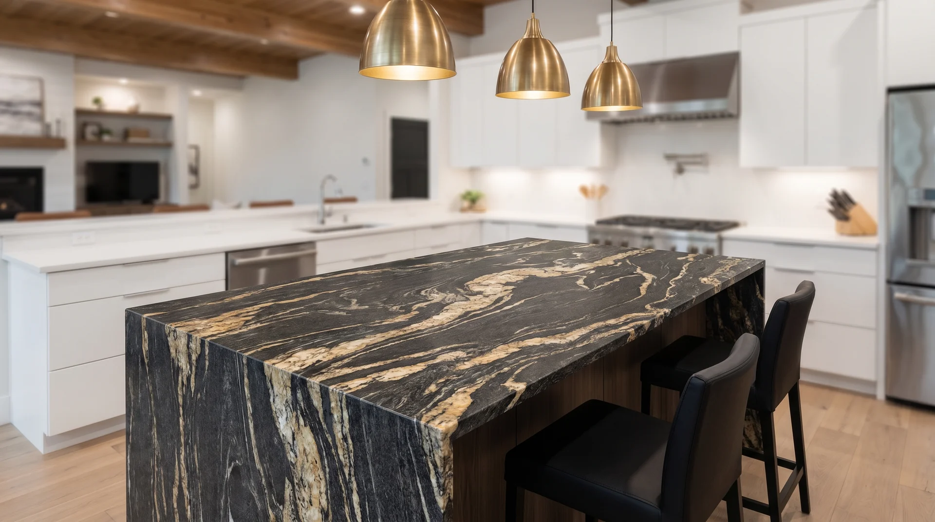 Titanium granite kitchen island with bold gold and cream swirls on black base, white flat-panel cabinetry