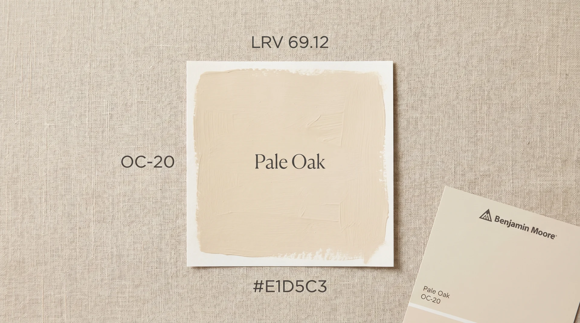 Benjamin Moore Pale Oak OC-20 paint swatch flat lay showing LRV 69.12 and color code on linen surface
