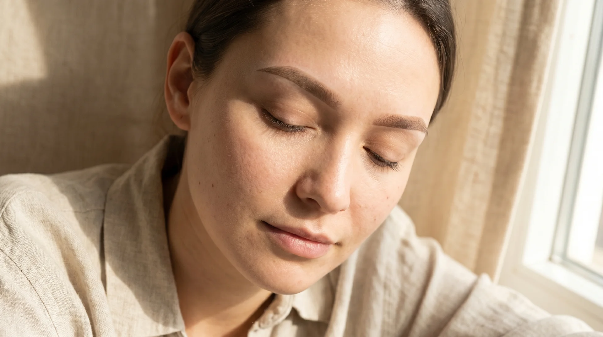Healed ombre powder brows on a woman's face in soft natural light, showing the soft gradient and defined tail