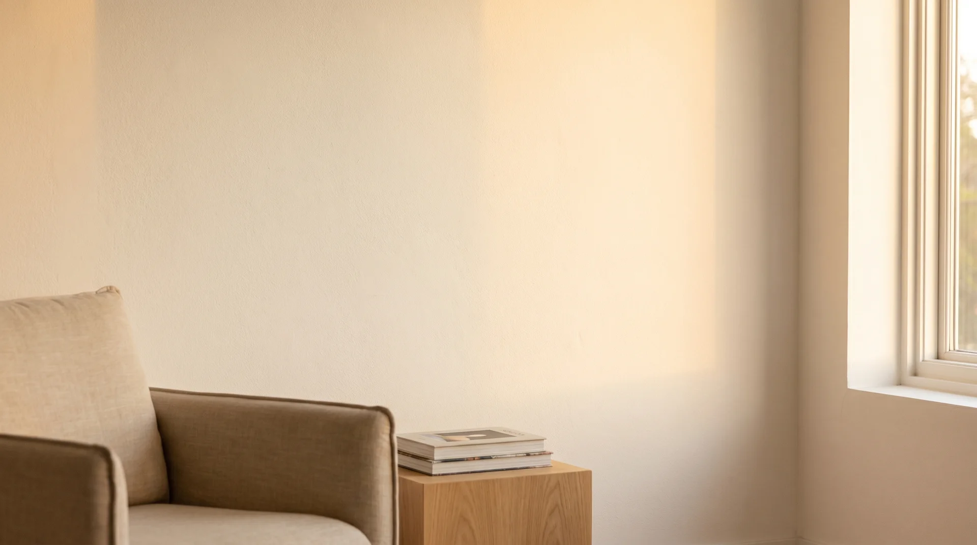 Warm afternoon light falling across a freshly painted Chantilly Lace wall in a bright, airy living room